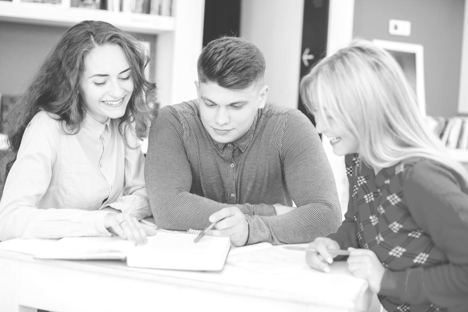 Students collaborating on budget forecasting exercises in modern learning environment